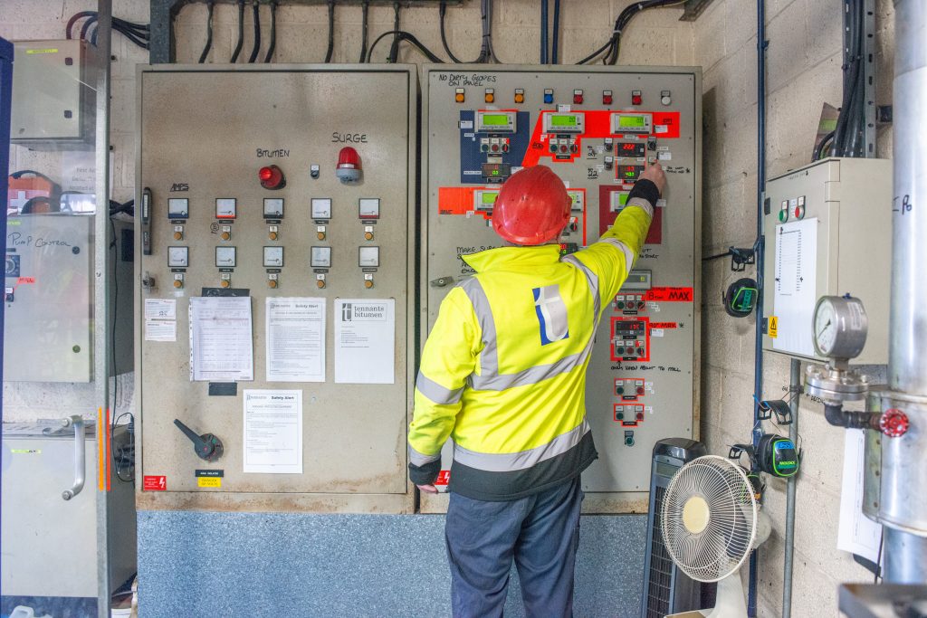 tennants bitumen employee checking the settings for the boiler house